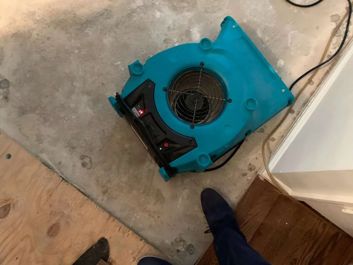 Air mover drying subfloor during Commercial Water Damage Restoration in Oceano